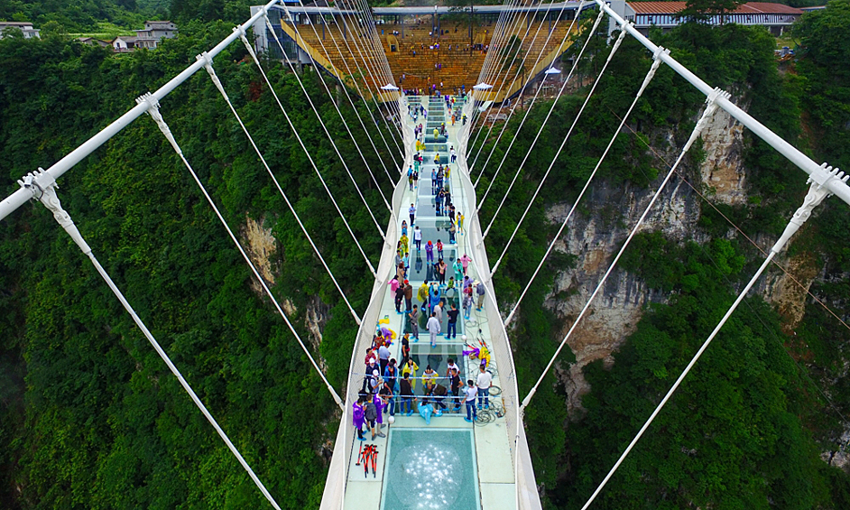 Zhangjiajie – специально построенный для развлечения туристов подвесной мост в китайской провинции Хунань. Он сделан из стекла и висит над ущельем глубиной 260 метров. Пройти по нему в полный рост способен далеко не каждый человек