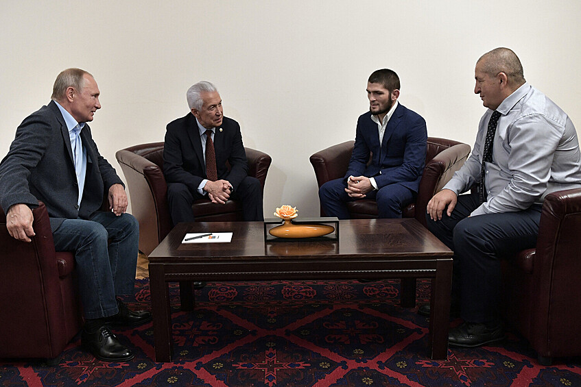 Президент РФ Владимир Путин, глава Дагестана (2018-2020) Владимир Васильев и чемпион абсолютного бойцовского чемпионата (UFC) в легком весе Хабиб Нурмагомедов с отцом и тренером Абдулманапом Нурмагомедовым (слева направо) во время встречи в аэропорту Махачкалы, 2019 год