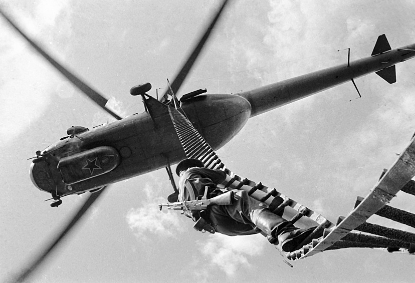 Солдат-пограничник спускается с вертолета по подвесной лестнице, 1969.