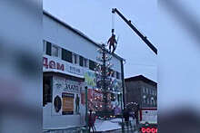 В Якутии висящий на крюке подъемного крана альпинист украсил елку и попал на видео