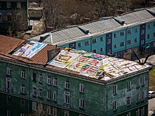 Крышу пятиэтажки на Котовского накрыли баннерами с рекламой шпикачек и кофе