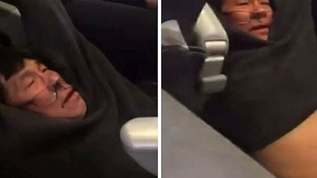 Скриншот из видеозаписи, на которой пассажира вытаскивают из самолета United Airlines в аэропорту Чикаго, 9 апреля 2017 года
