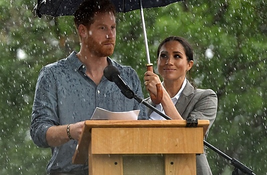 Просто чудо: беременная Маркл раскрыла зонт над принцем Гарри во время ливня на измученной засухой ферме