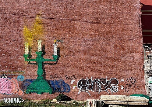 Граффити с подсвечником появилось на стене ОКН на Большой Покровской