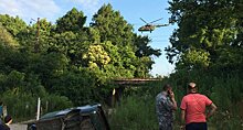 Военный вертолет летает над зоной поиска напавших на туристов из России