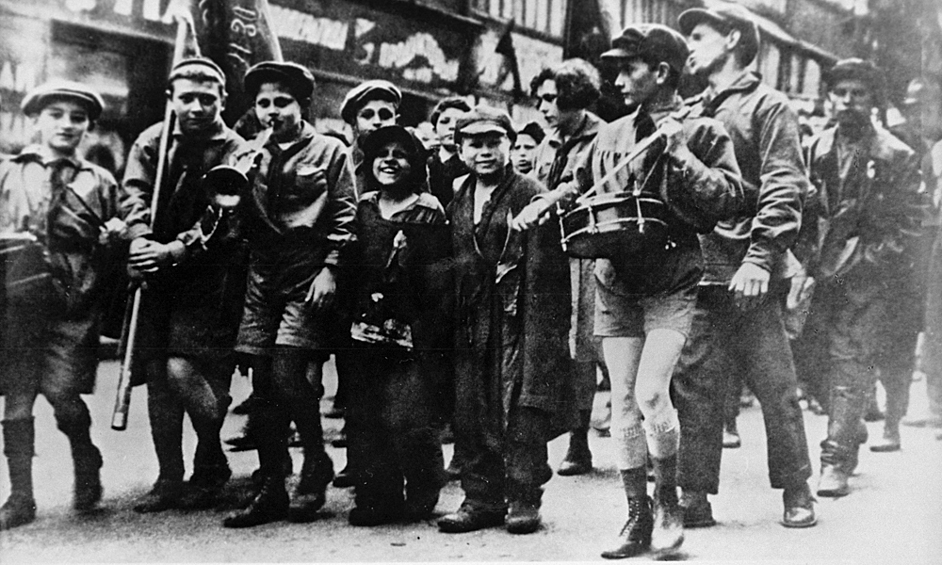По городу марширует один из первых пионерских отрядов, к которому присоединились беспризорники, 1922 год