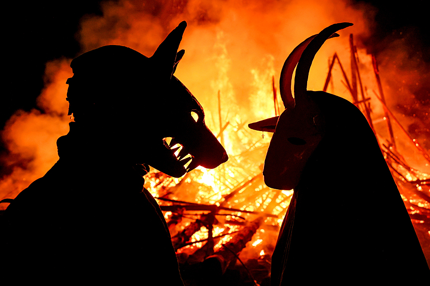 Участники масленичных гуляний во время сожжения деревянного замка с башнями-мельницами высотой 26 метров в арт-парке "Никола-Ленивец", март 2025 года