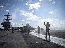 Что произошло в мире 14 января: посадка на Титан и пожар на борту авианосца ВМС США