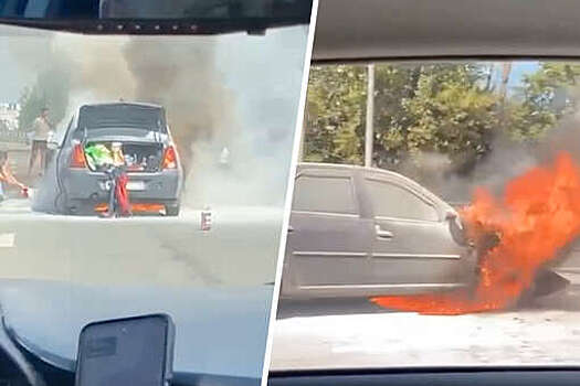 В Москве автомобилисты пытаются потушить загоревшуюся на дороге машину