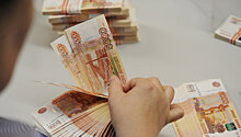 Средневзвешенный курс доллара вырос на 1,3 рубля